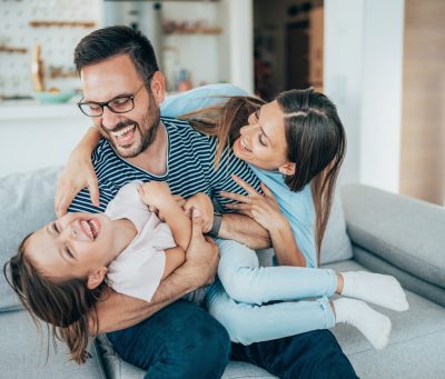 Family with daughter having fun at home